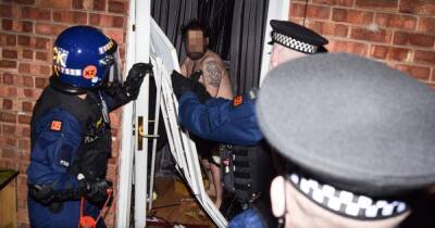 'You're famous': Shirtless man's door smashed down as cops storm homes and make dozens of arrests