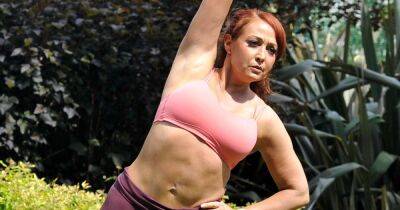 The Apprentice star Amy Anzel works up a sweat as she shows off her weight loss during outdoor yoga session
