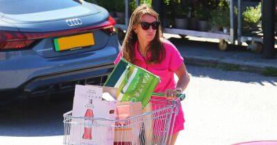 Coleen Rooney looks pretty in pink in tennis-style outfit as she does supermarket run in her medical boot