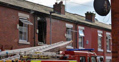 Residents escape blaze as fire crews smash through bedroom window of Manchester home